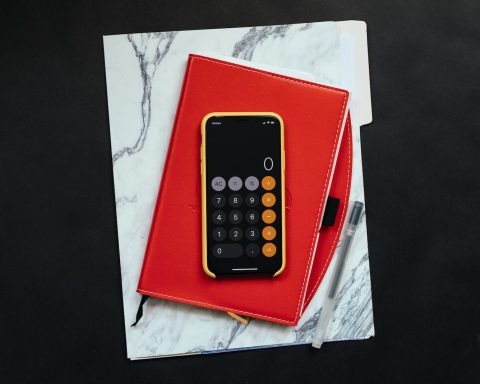 black Android smartphone on red flip case