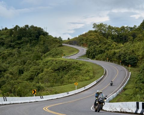 a motorcyclist rides down a curved road