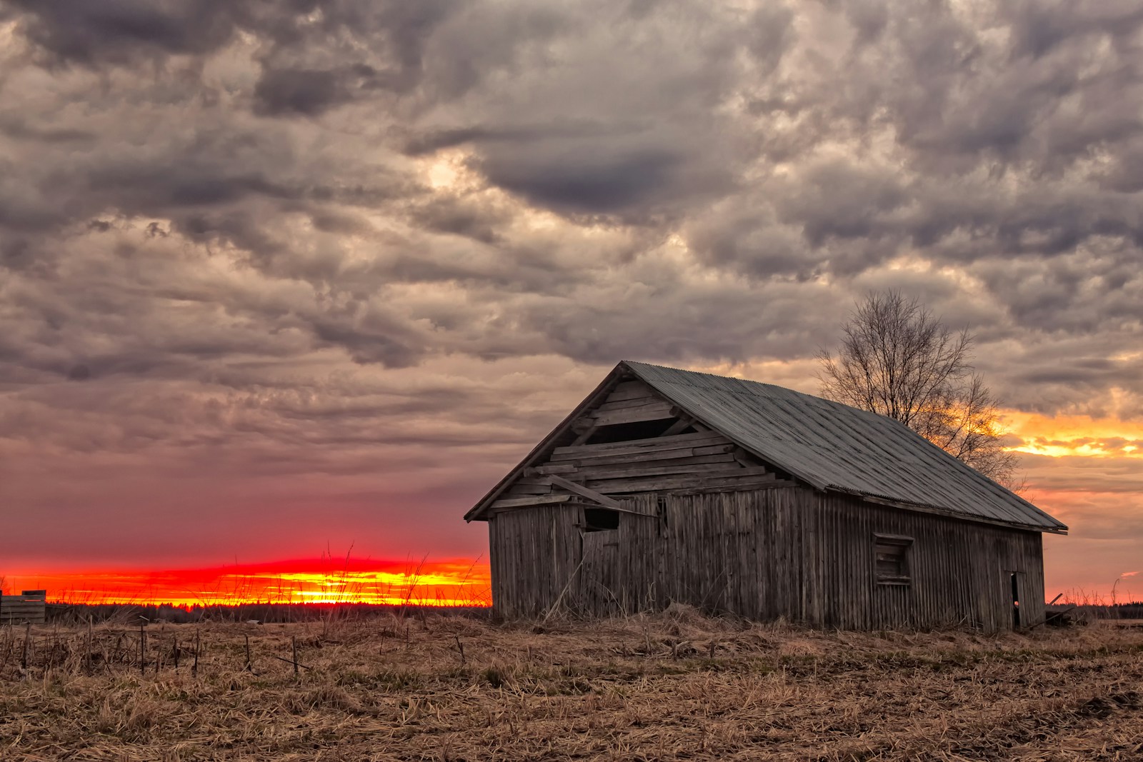 gray wooden house under gray sky