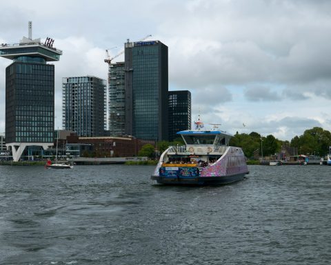 a boat in a body of water with a city in the background