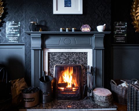 black fireplace with brown wooden frame