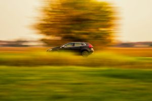 black SUV near grass and trees