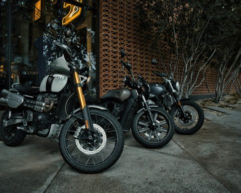 two motorcycles parked next to each other in front of a building