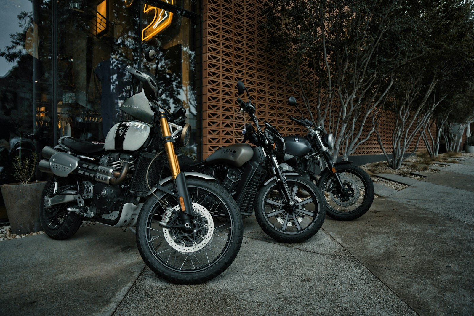 two motorcycles parked next to each other in front of a building