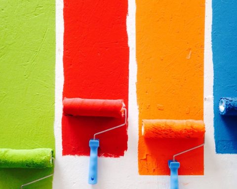 four orange, green, blue, and red paint rollers