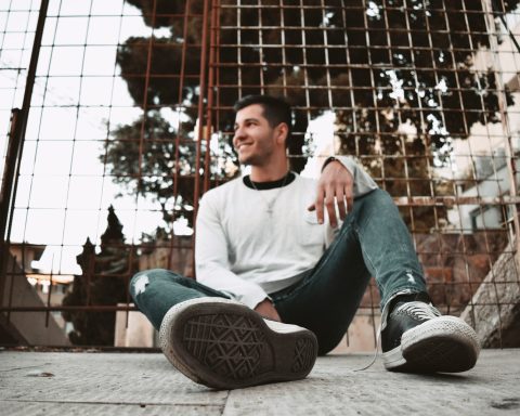 A man sitting on the ground with his legs crossed