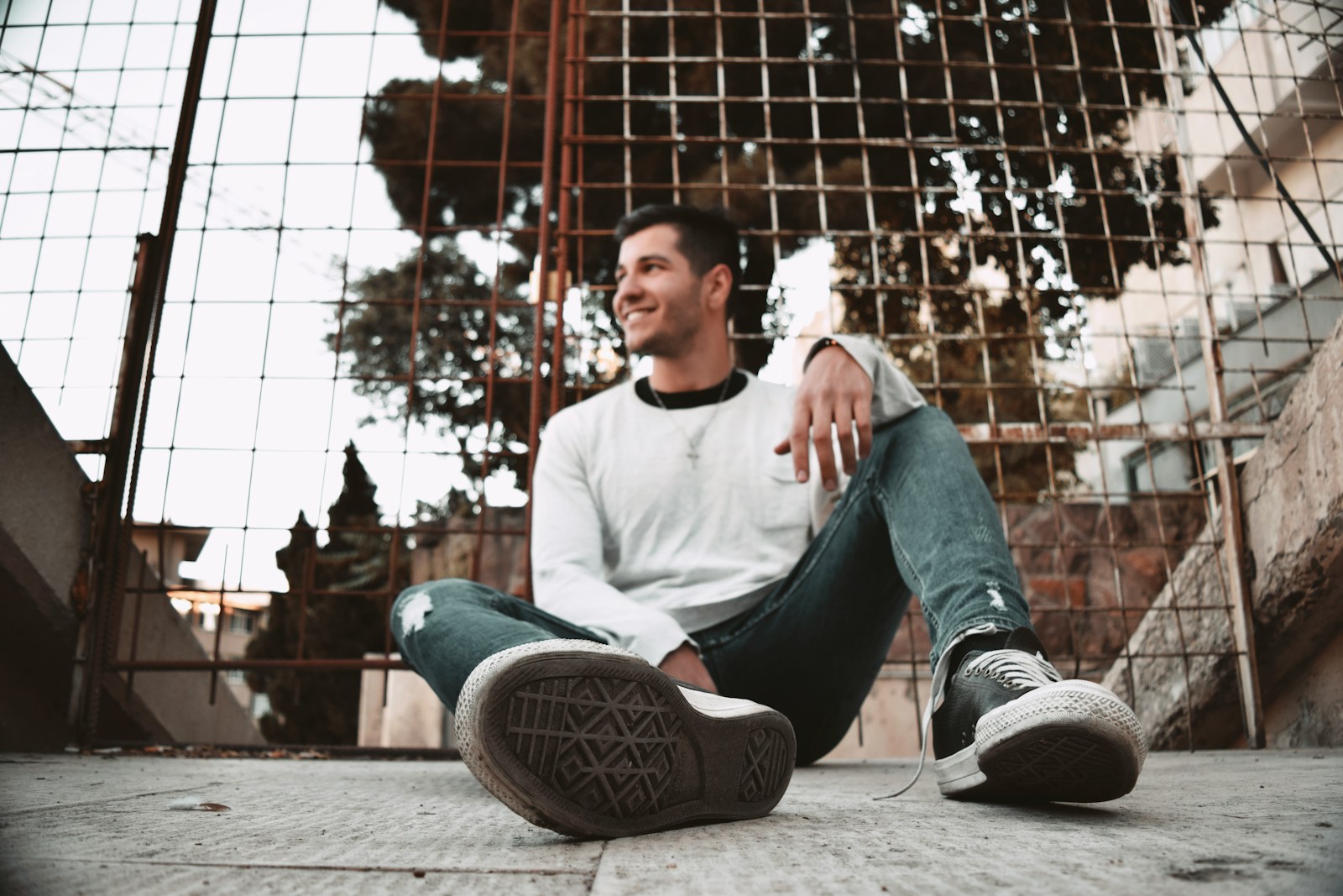 A man sitting on the ground with his legs crossed