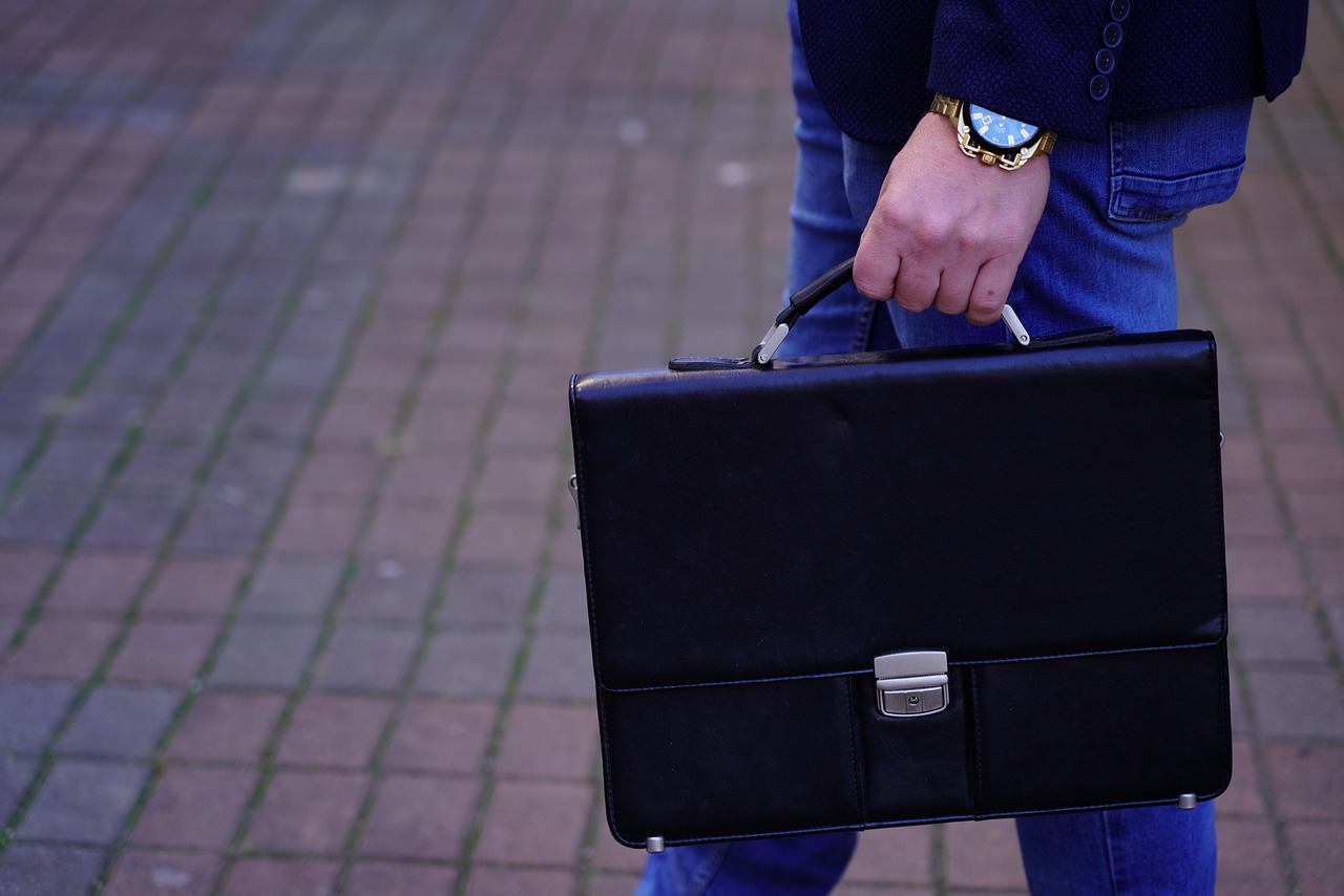 Man met een lederen schoudertas in stedelijke omgeving